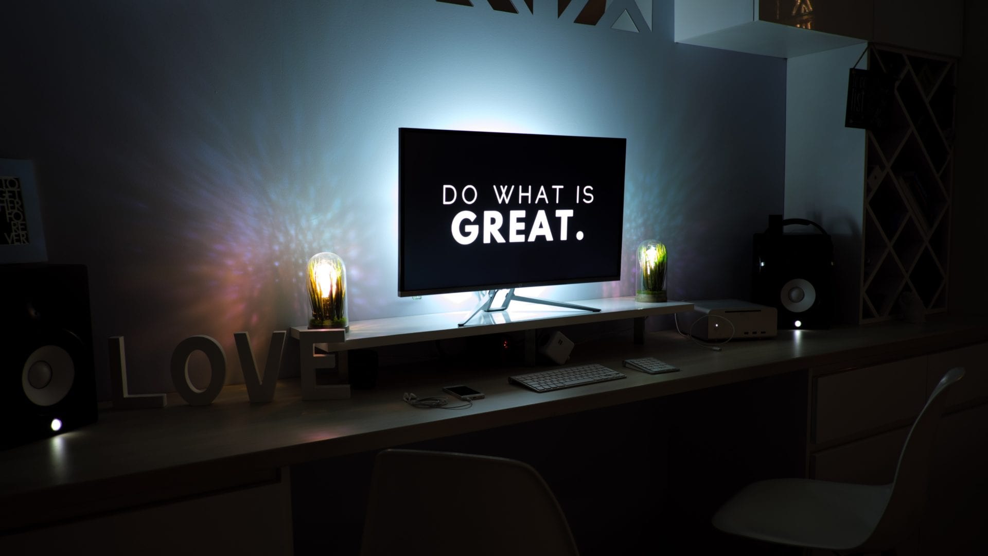 A desk with a computer and a lamp for a social media manager working on digital marketing strategies.