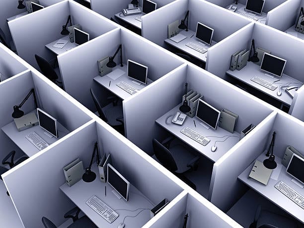 A cluster of cubicles with desks and computers, offering IT services and website design.