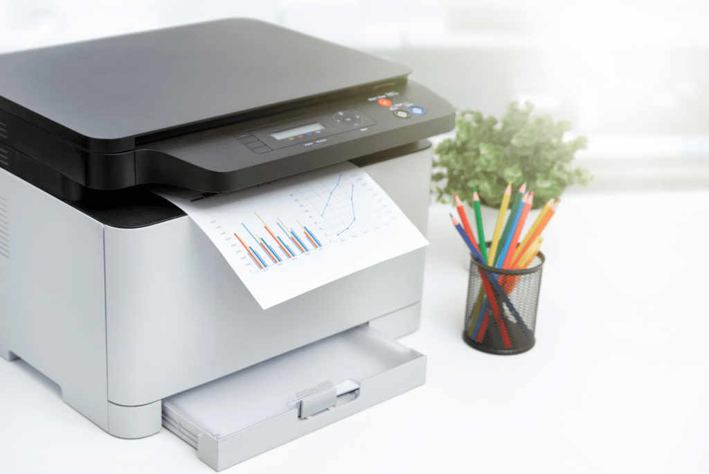 A printer is sitting on a table in an office that provides IT services.