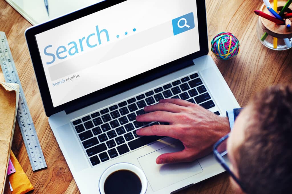 A man is using a laptop for digital marketing.