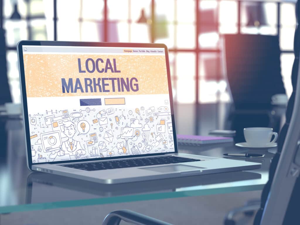 Local Marketing Concept. Closeup Landing Page on Laptop Screen in Doodle Design Style. On Background of Comfortable Working Place in Modern Office. Blurred, Toned Image. 3D Render.
